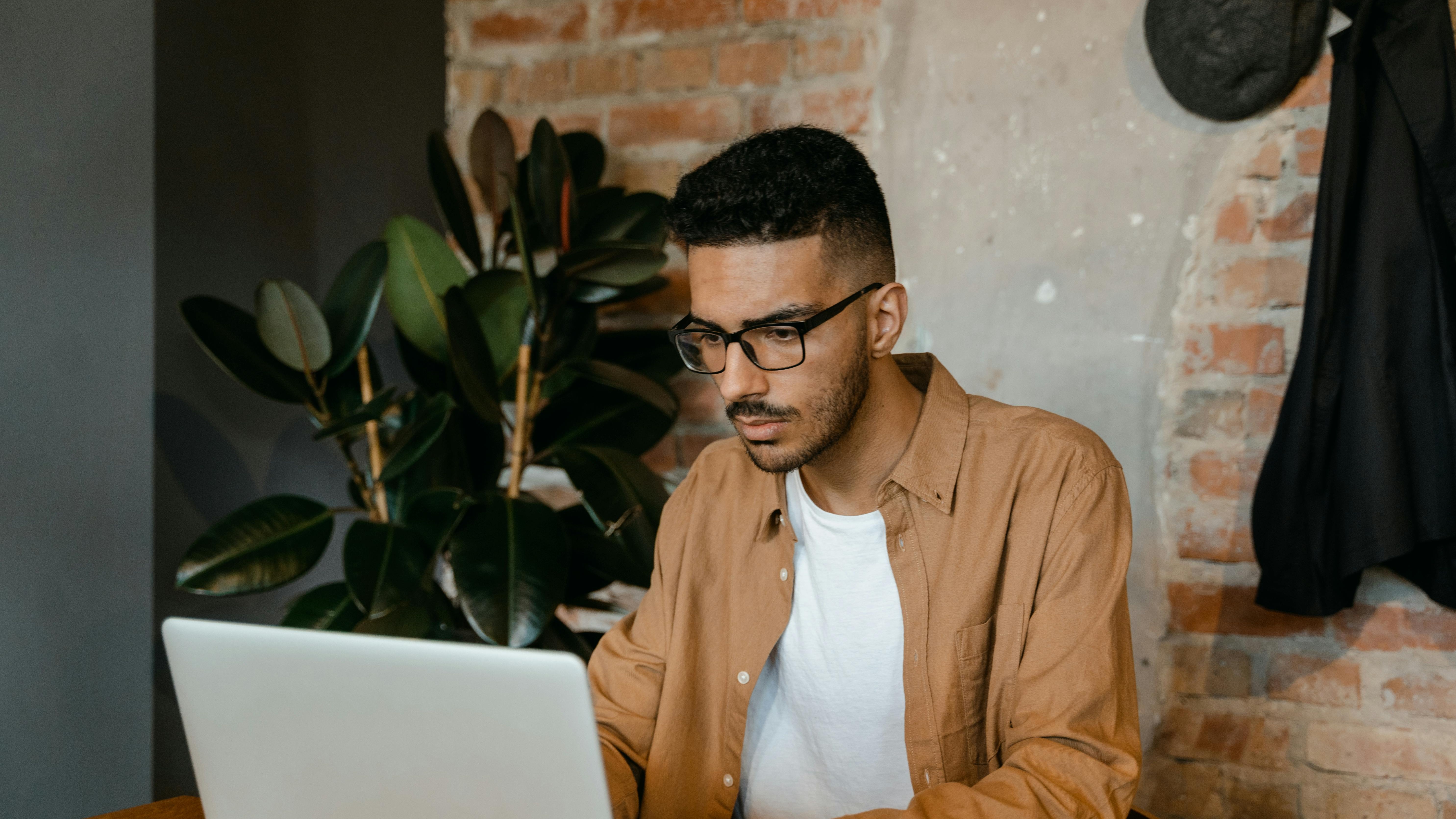 South African business professional working on laptop in modern workspace